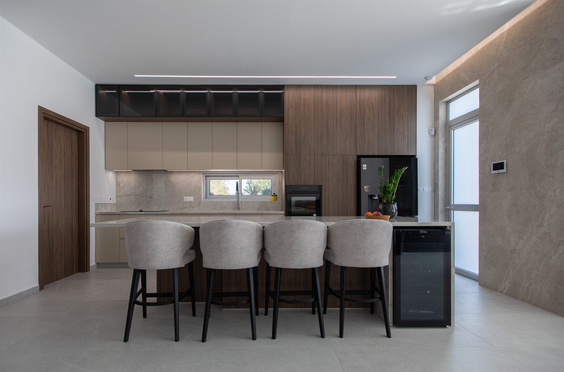 Contemporary fitted kitchen with timber and stone finishes