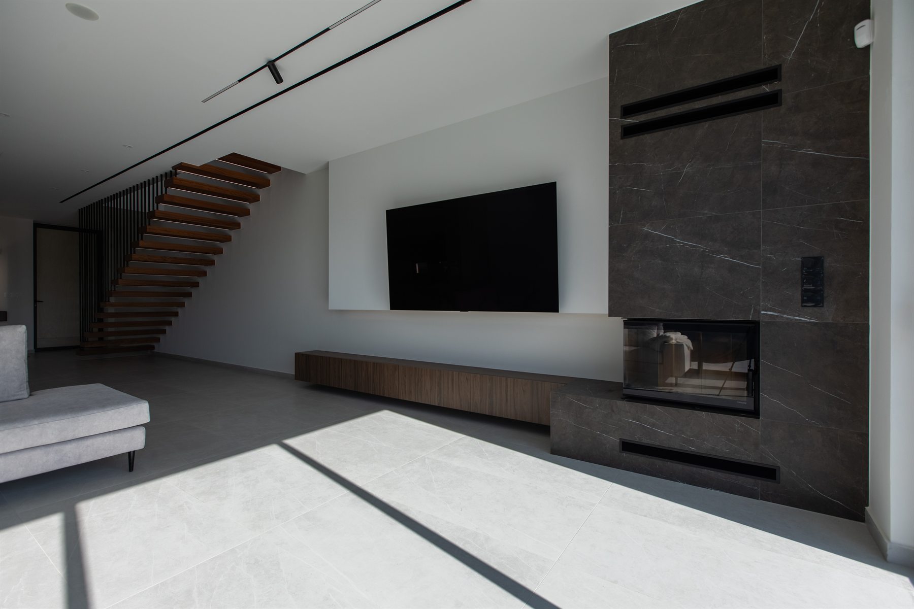Integrated media wall with timber cabinetry and stone fireplace