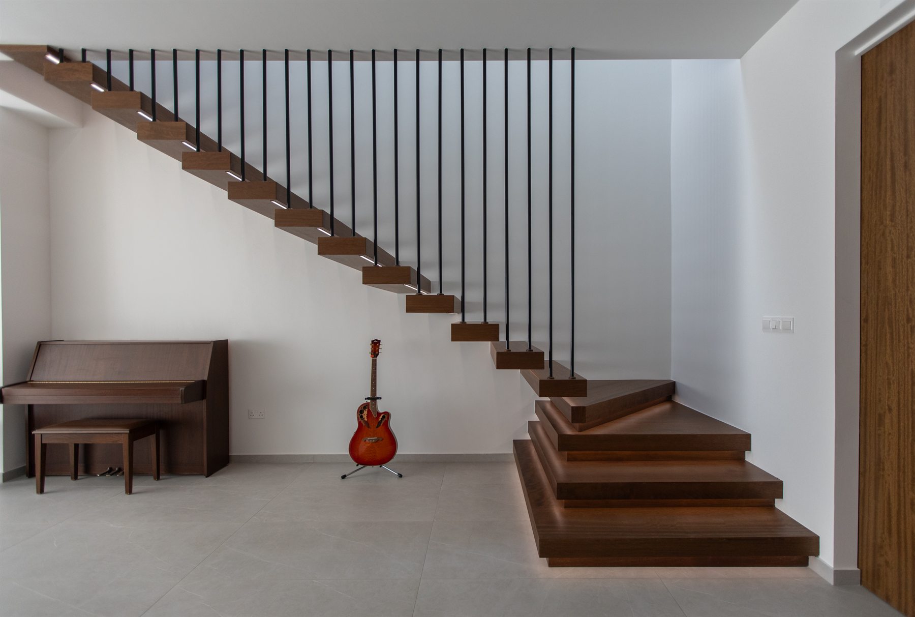 Floating timber staircase with black metal balustrade